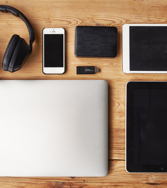 tech items laying on wooden table